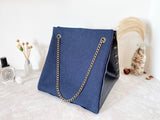 Black textured leather button cube bag - blue denim