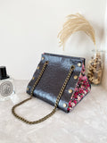 Black textured leather button cube bag - red floral
