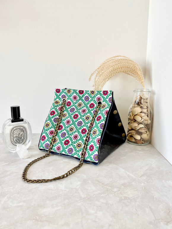 Black textured leather button cube bag - green flower tiles