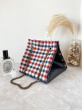 Black textured leather button cube bag - red blue checker