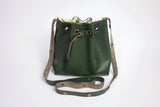 Green leather bucket bag with floral lining