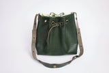 Green leather bucket bag with floral lining