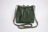 Green leather bucket bag with chevron lining