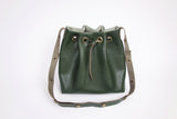 Green leather bucket bag with chevron lining
