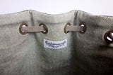 Green leather bucket bag with chevron lining