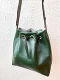 Green leather bucket bag with chevron lining