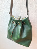 Green leather bucket bag with floral lining