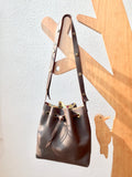 Brown bucket bag with yellow floral lining