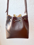 Brown bucket bag with yellow floral lining