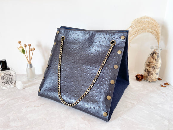 Black textured leather button cube bag - blue denim