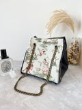 Black textured leather button cube bag - storybook print
