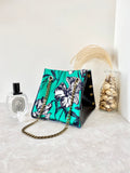 Black textured leather button cube bag - green floral sketch