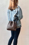 Brown bucket bag with striped lining