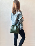 Green leather bucket bag with floral lining