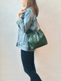 Green leather bucket bag with chevron lining