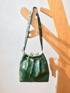 Green leather bucket bag with floral lining