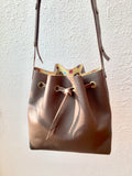 Brown bucket bag with yellow floral lining