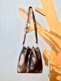 Brown bucket bag with striped lining